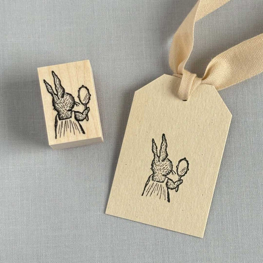 A sticker of a rabbit looking in the mirror