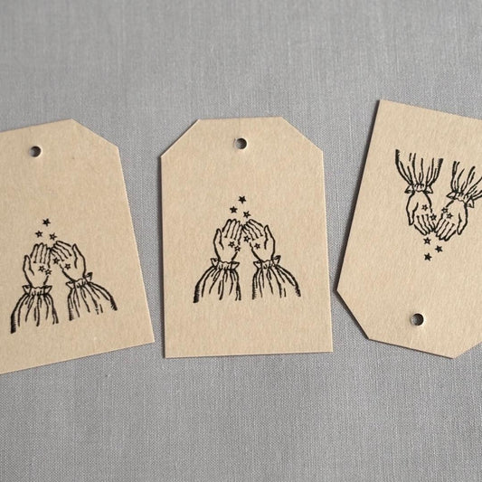 Stamp of hands collecting star sand